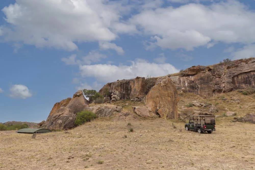 Sandstone hill and safari vehicle, Mapungubwe Hill heritage tour
