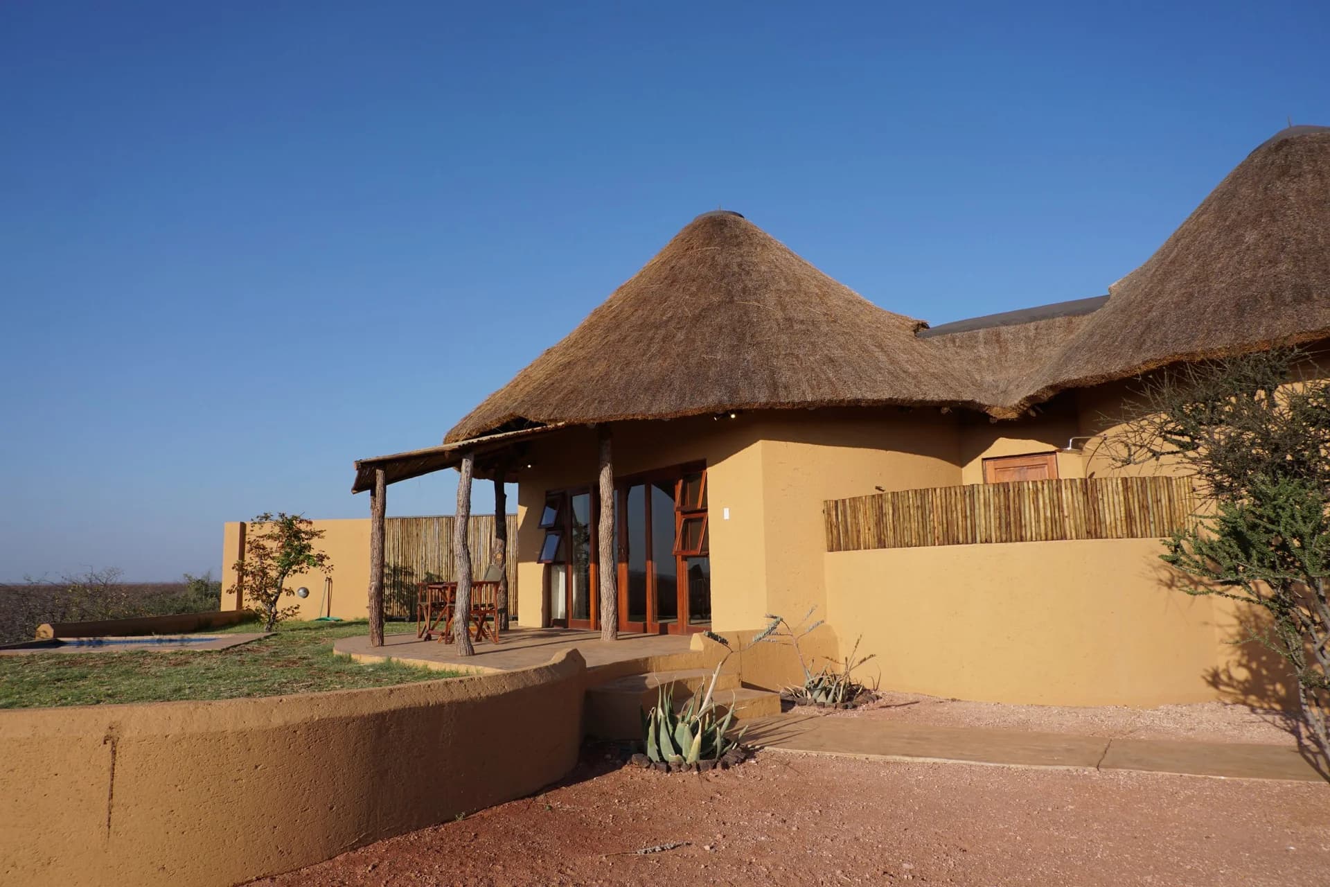 Thatched lodge exterior and terrace, Mopane Bush Lodge