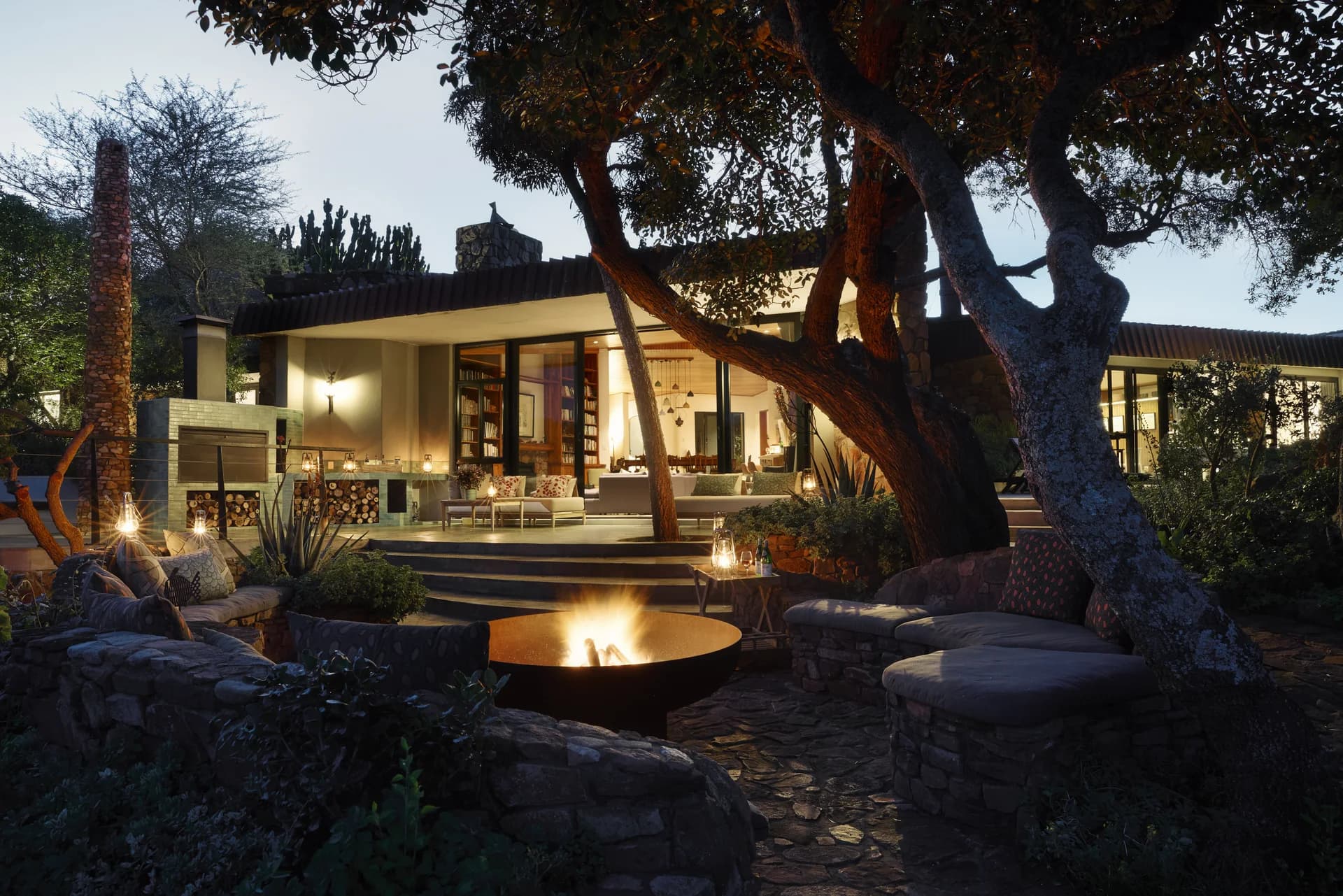 Illuminated modern villa and fire pit at dusk, The Farmhouse at Leshiba