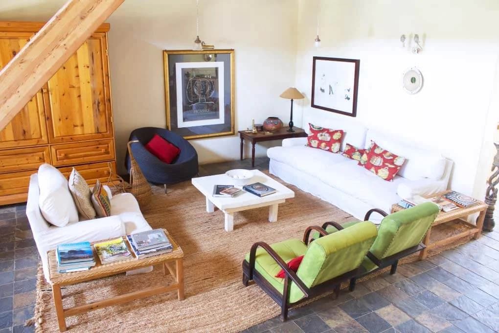 Lounge with timber floor and colourful chairs, Mogalakwena Artist's Retreat