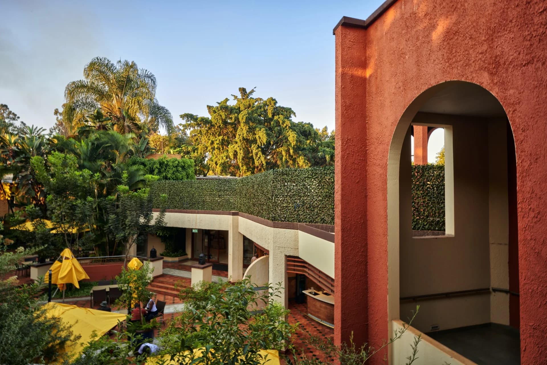 Terracotta hotel building and garden courtyard, Khoroni Hotel