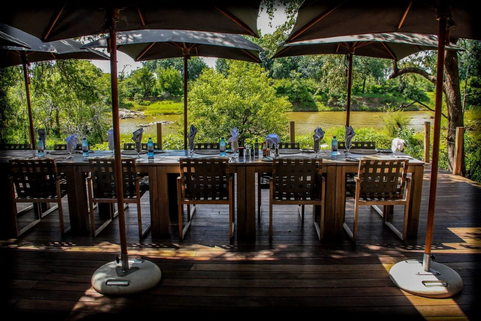 Open-sided dining area overlooking green vegetation, Koro River Camp