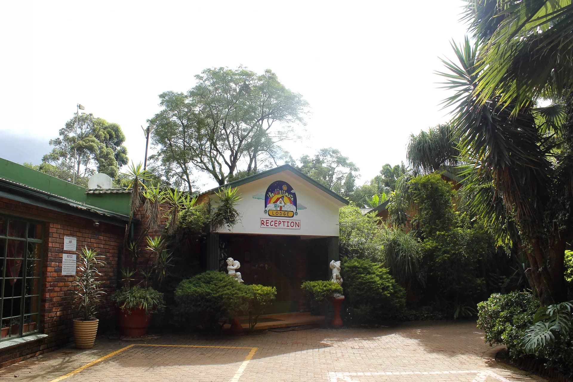 Lodge reception building surrounded by garden plants, The Ultimate Lodge